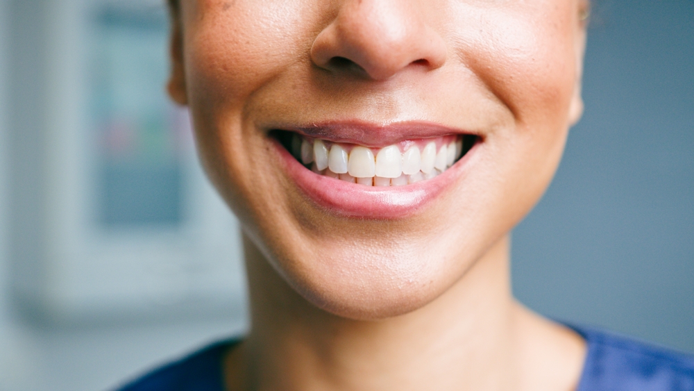 Close up of a woman's healthy smile after treatment for painful gums at Bagoff Dental Arts