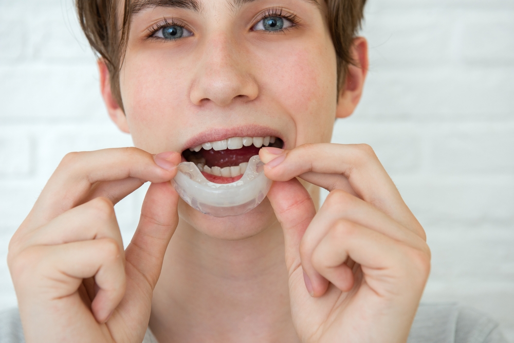 Young patient fitting a custom mouthguard, the kind of personalized care Bagoff Dental Arts provides for patients in the Montclair, NJ community